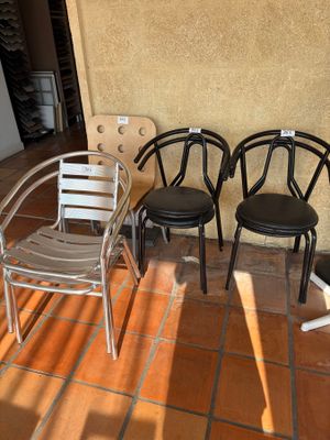 three chairs that are sitting on the floor outside