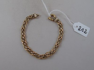 a close up of a gold bracelet with a tag on it
