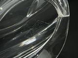 a close up of a glass ashtray on a table