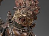 bronze statue of a person holding a sword and a shield