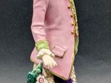 an image of a figurine of a man with a dog