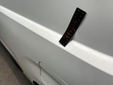 a sticker on the side of a white car that has a sticker on it