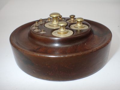 une petite boîte en bois ornée de boutons en laiton