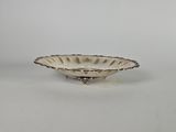 a silver plate with a decorative design on the rim