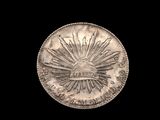 a close up of a silver coin on a black background