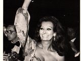 an old black and white photo of a woman waving her hand