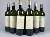 six bottles of wine are lined up in a row