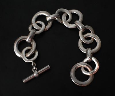 a close up of a chain bracelet with a silver clasp
