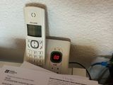 a cell phone sitting on top of a table next to a book