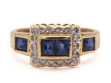 a yellow gold ring with blue sapphires and diamonds