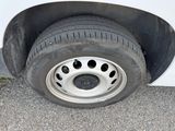a white van with a flat tire on the street