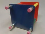 two pencils sticking out of the back of a blue and red box