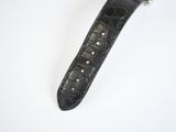 an image of a watch with a black leather strap on a white surface