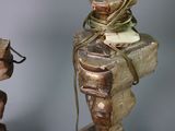 a statue of a man that is tied up to a pole