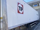 a truck that has a tip sign on the side of it