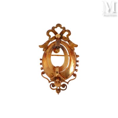 an image of a gold broochle on a white background