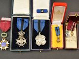several medals and medals are displayed in a case on a table