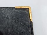 an image of a black wallet with a gold clasp on it