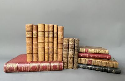 several old books stacked on top of each other on a table