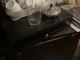 a black table with a bunch of white dishes on it