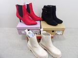 three pairs of boots are stacked on top of each other