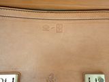 a close up of a brown leather bag with numbers on it