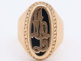 an image of a gold ring with a monogram on it