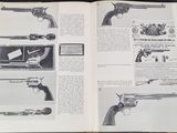 an open book with a bunch of guns on it