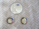 three coins sitting on top of a woven table next to each other