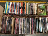 beaucoup de DVD dans une boîte posée par terre
