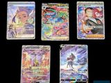 Quatre cartes à collectionner Pokémon différentes sont représentées sur un fond noir.