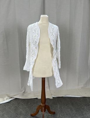 the mannequin is holding a white lace jacket on it ' s head