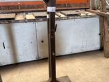 several pieces of metal are sitting on a stand in a room