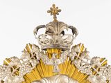 a gold and silver clock with a crown on top of it
