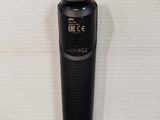 a black electric shaver sitting on a white surface