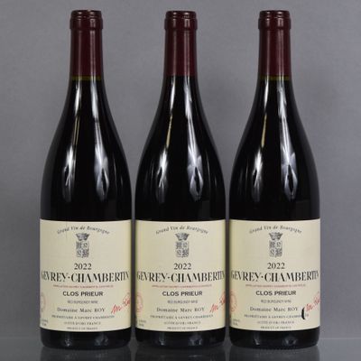 three bottles of wine are lined up on a table