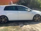 the car is parked on the side of the road in the yard