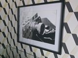 a picture hanging on the wall of a bathroom