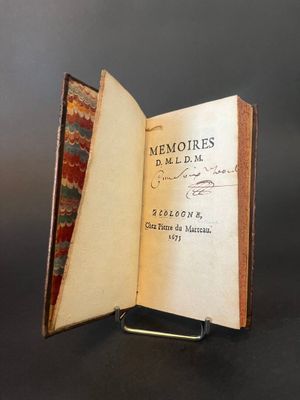 an open book sitting on top of a table next to a black background