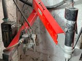 an image of a red and black machine with a red handle
