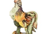 a figurine of a rooster standing on a plate