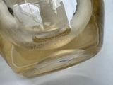 a glass vase with a boat in it on a table
