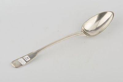 an antique silver spoon with a handle on a white surface