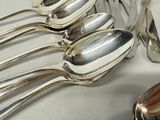 five spoons and two spoons sitting on a table