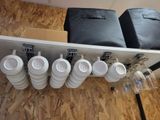a shelf with cups and a bag on it