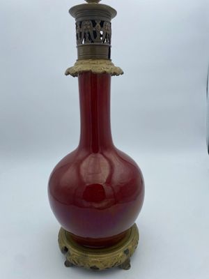 a red vase that is sitting on top of a table