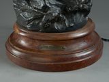 a bronze statue of a man riding a horse on a rock