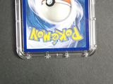 a pokemon card in a plastic case on a table