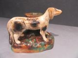 a figurine of a dog that is standing on a table