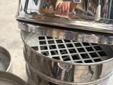a metal trash can with a lid on it